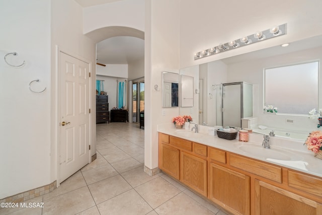 bathroom featuring shower with separate bathtub, tile patterned floors, and vanity