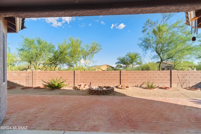 view of patio featuring an outdoor fire pit and a fenced backyard