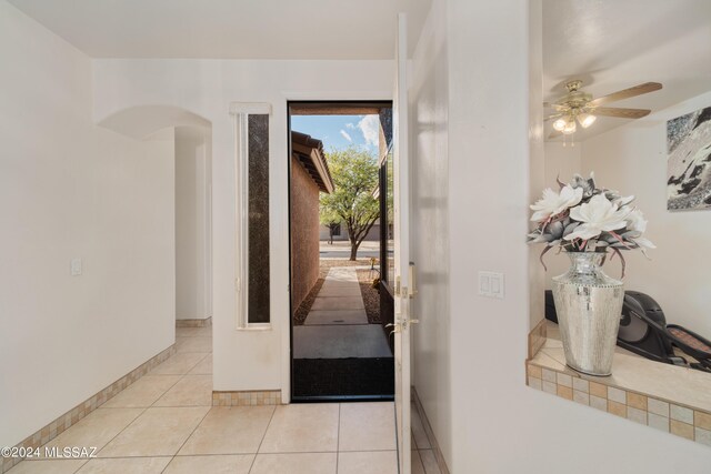 entryway with ceiling fan and light tile patterned flooring