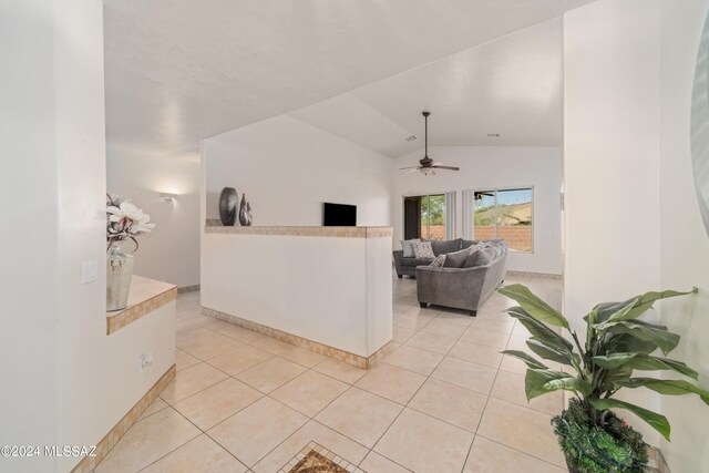 living room with light tile patterned floors, lofted ceiling, and ceiling fan