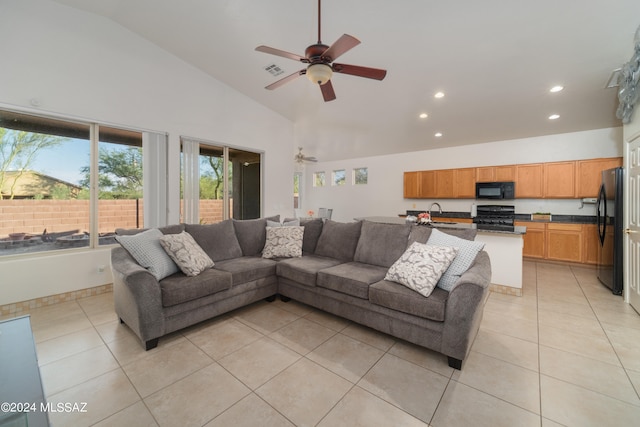 living room with high vaulted ceiling, ceiling fan, and light tile patterned floors