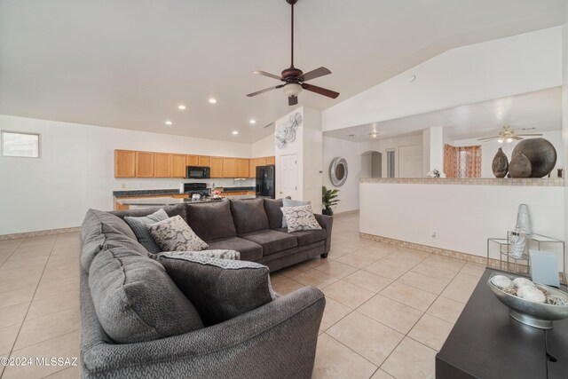 living room featuring high vaulted ceiling, ceiling fan, and light tile patterned floors