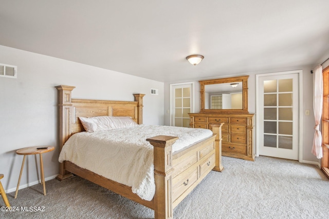 bedroom featuring baseboards, visible vents, and light carpet