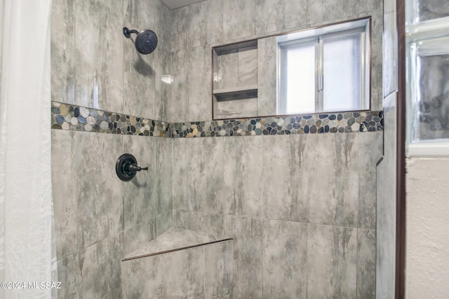 interior details with a tile shower