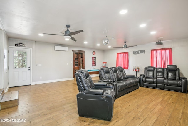 cinema with light wood-style flooring, a wall mounted air conditioner, ceiling fan, and recessed lighting