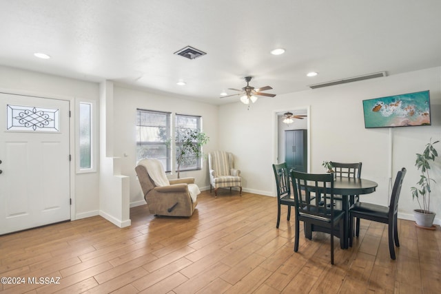 dining room featuring baseboards, visible vents, and light wood finished floors