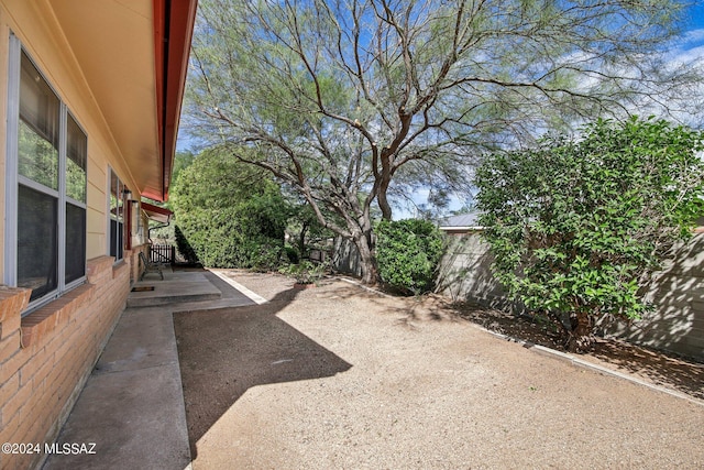 view of yard with fence and a patio area