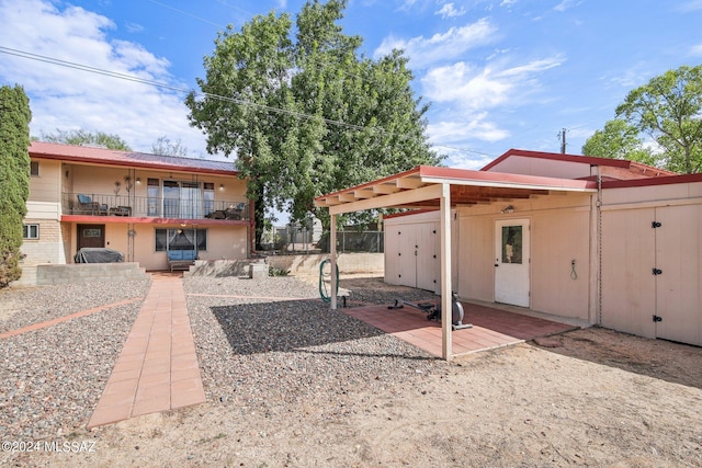 exterior space with a balcony and fence
