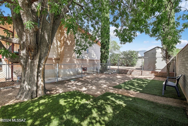 view of yard with a fenced backyard, a gate, and a patio area