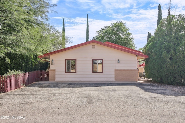 view of home's exterior with fence and a patio area