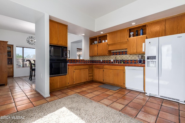 kitchen featuring light tile patterned floors, open shelves, backsplash, a sink, and black appliances