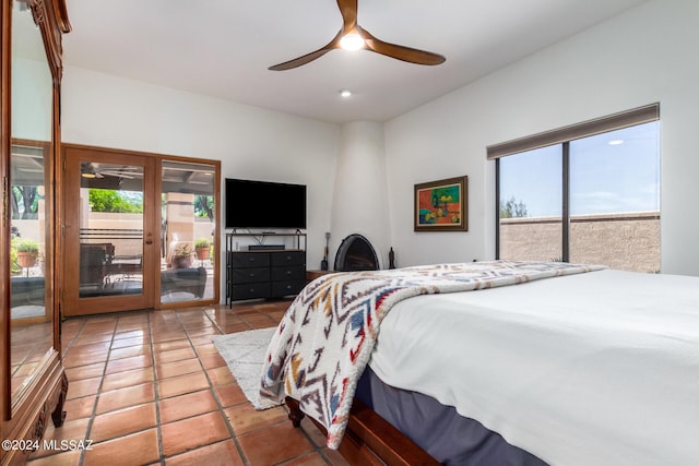 bedroom featuring access to exterior, a ceiling fan, multiple windows, and light tile patterned floors