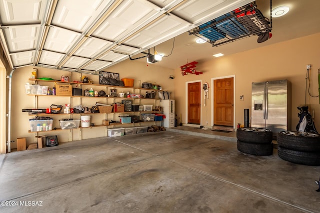 garage with water heater, stainless steel fridge, and a garage door opener