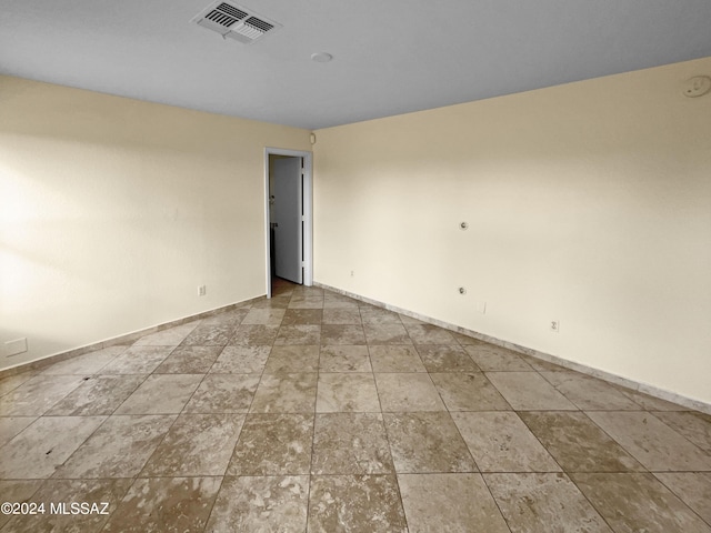 empty room with visible vents and baseboards