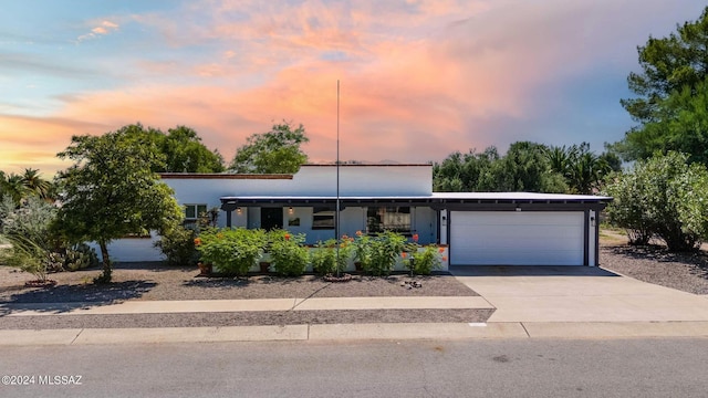 view of front of property with a garage and concrete driveway