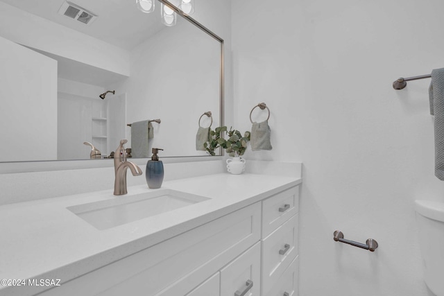 full bathroom featuring visible vents, walk in shower, and vanity