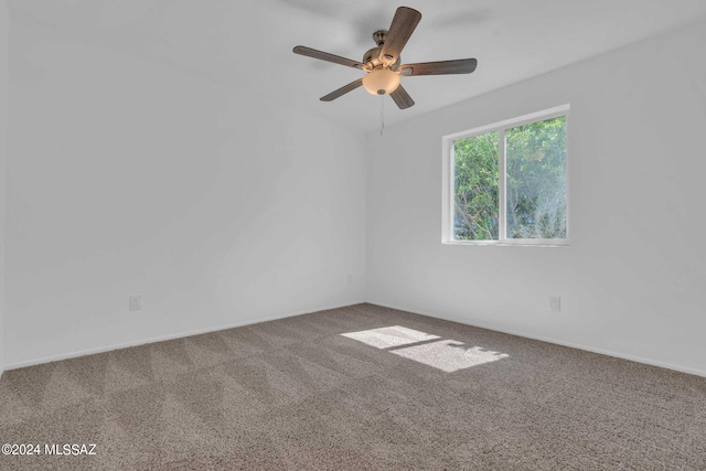 carpeted empty room with a ceiling fan