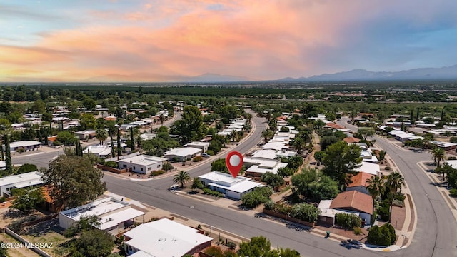 aerial view at dusk featuring a mountain view