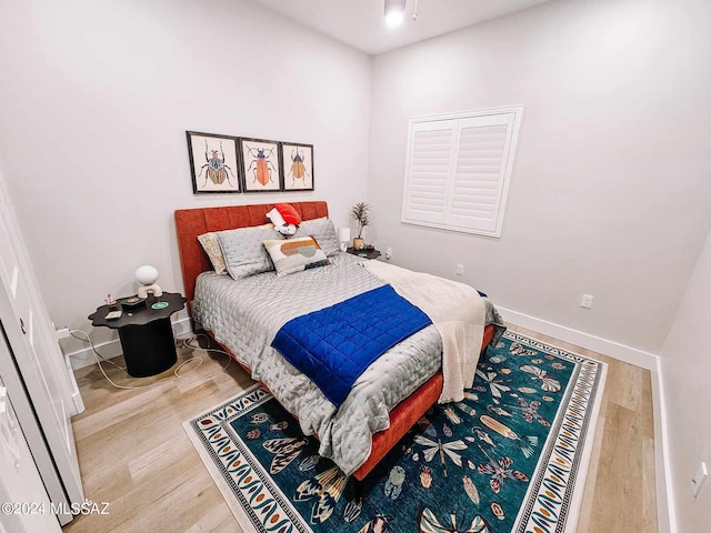 bedroom featuring baseboards and wood finished floors