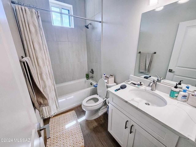 bathroom with vanity, shower / bath combo with shower curtain, wood finished floors, and toilet