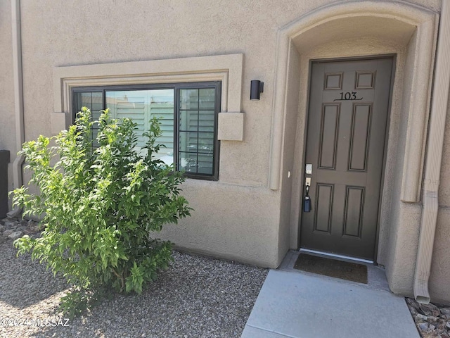 doorway to property with stucco siding