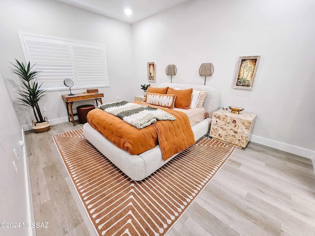 bedroom featuring baseboards and wood finished floors