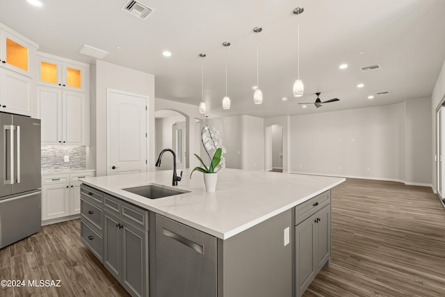 kitchen with white cabinets, sink, ceiling fan, dark hardwood / wood-style floors, and stainless steel appliances