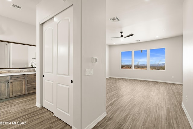 corridor with light hardwood / wood-style floors