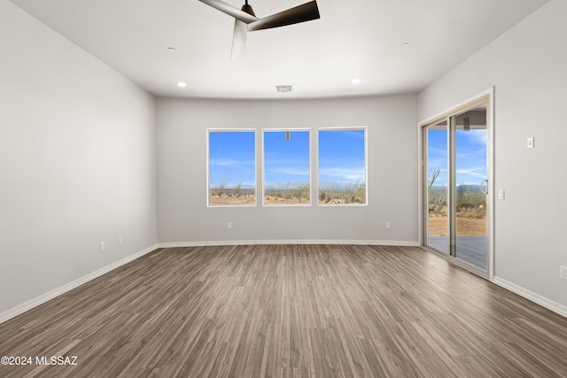 spare room with hardwood / wood-style floors and ceiling fan