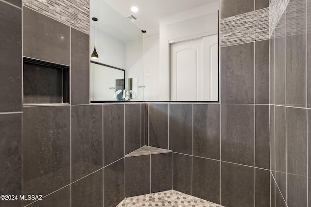 bathroom with a tile shower