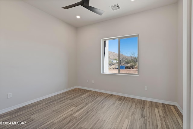 unfurnished room featuring ceiling fan and light hardwood / wood-style floors