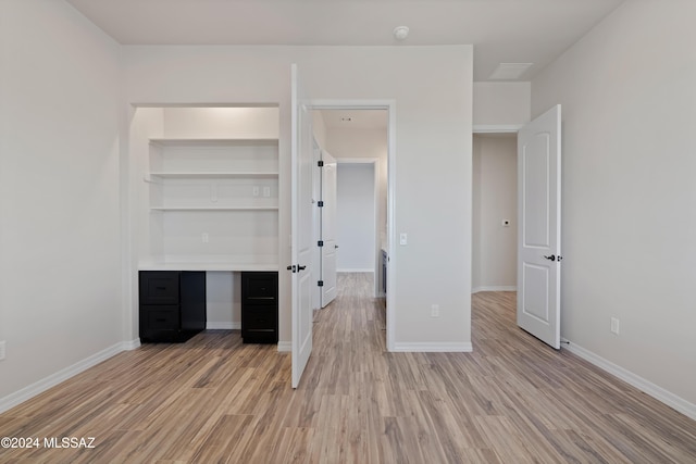 unfurnished bedroom featuring light hardwood / wood-style flooring and a closet