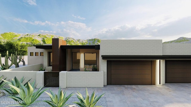 view of front of property with a mountain view and a garage