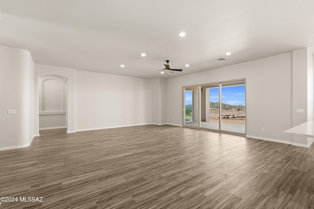 spare room with ceiling fan and dark hardwood / wood-style flooring