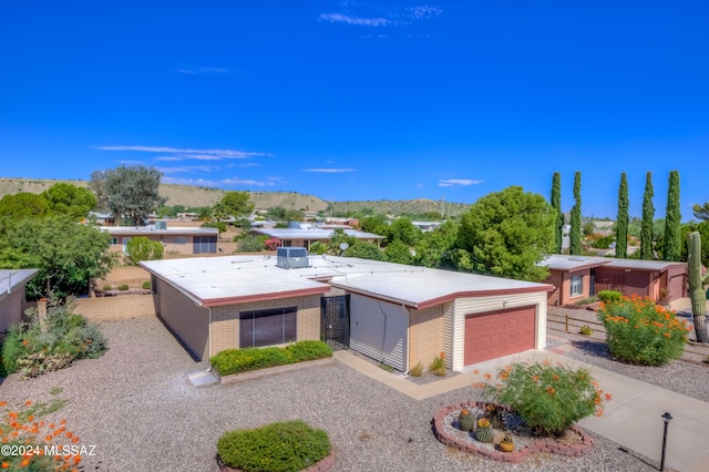 view of front of property featuring a garage and a mountain view