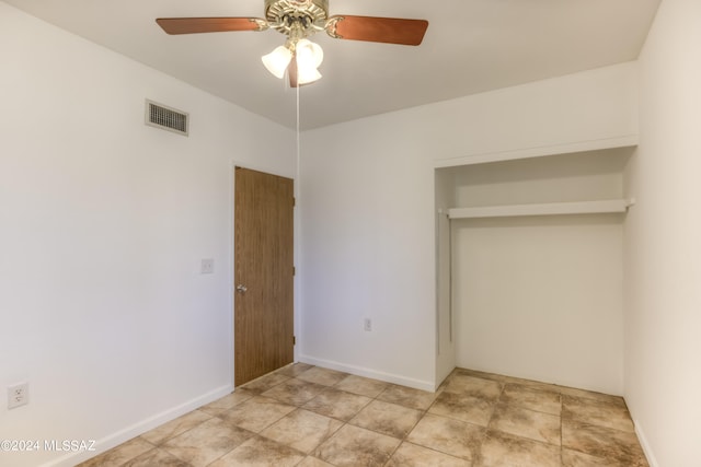 unfurnished bedroom with a closet, ceiling fan, and light tile patterned floors