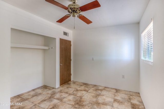 unfurnished bedroom featuring light tile patterned floors, ceiling fan, and a closet