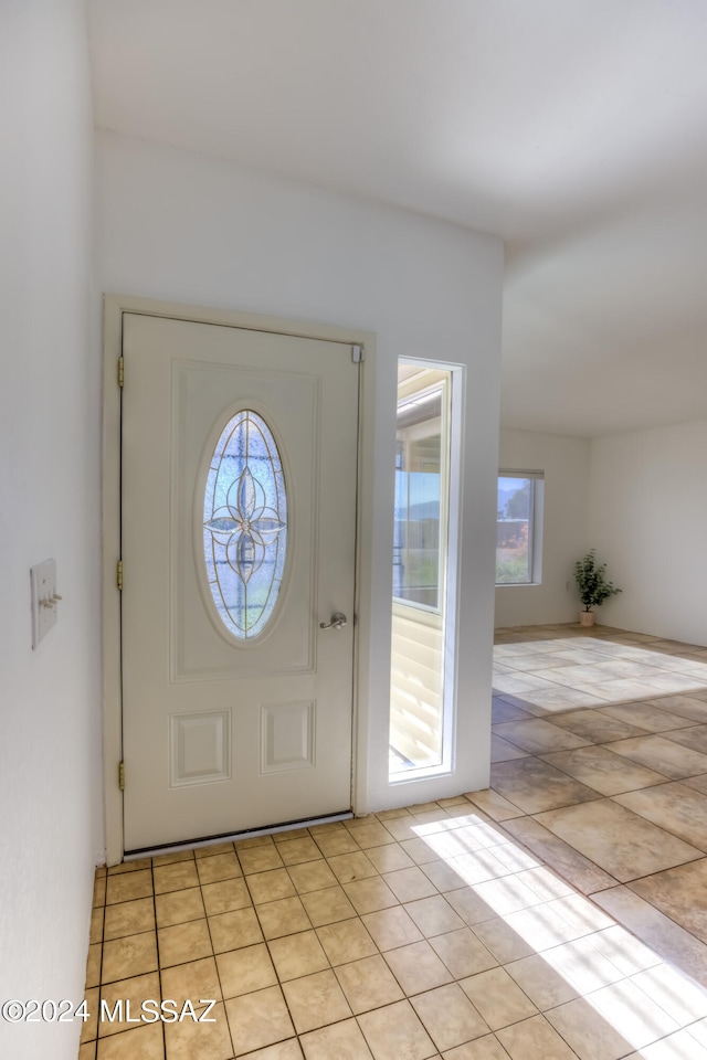 entryway with light tile patterned floors