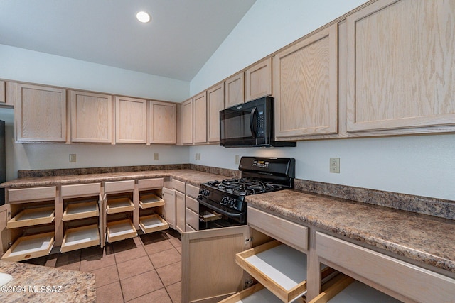 kitchen featuring lofted ceiling, black appliances, light brown cabinets, and light tile patterned flooring