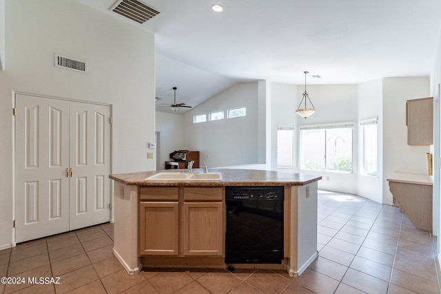 kitchen featuring vaulted ceiling, black dishwasher, light tile patterned floors, an island with sink, and ceiling fan