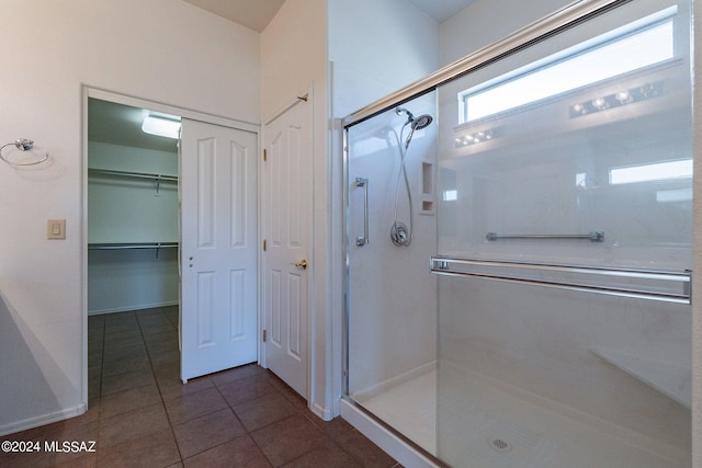 bathroom with walk in shower and tile patterned floors