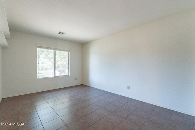 unfurnished room with tile patterned flooring, baseboards, and visible vents