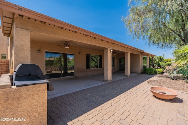 view of patio / terrace featuring a fire pit and ceiling fan