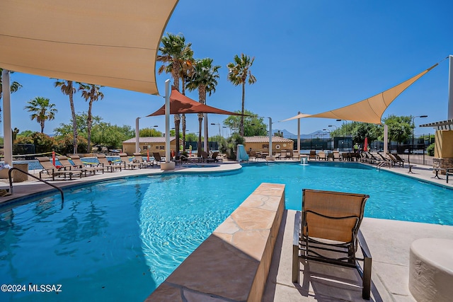 pool featuring a patio and fence