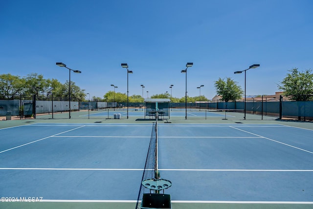 view of tennis court featuring fence