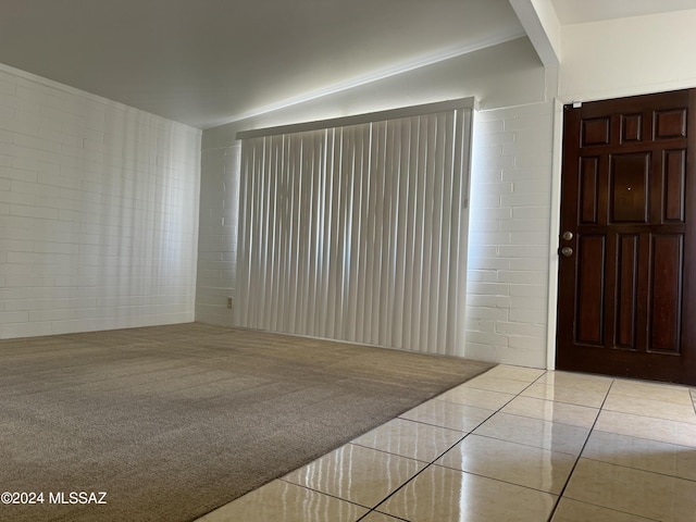 unfurnished room featuring carpet and tile patterned flooring