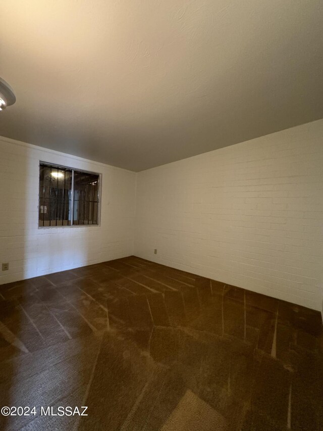 empty room featuring dark colored carpet