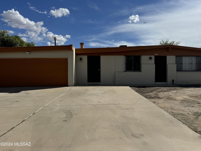 ranch-style home with brick siding, driveway, and a garage