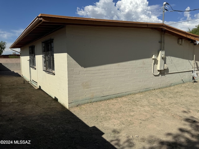 view of side of property featuring brick siding