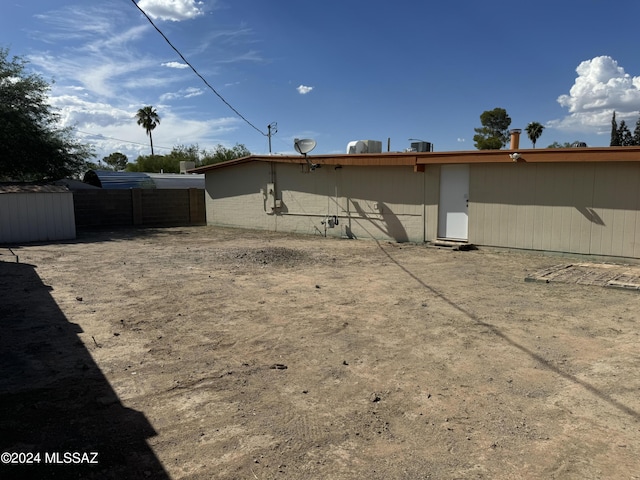 rear view of house with fence